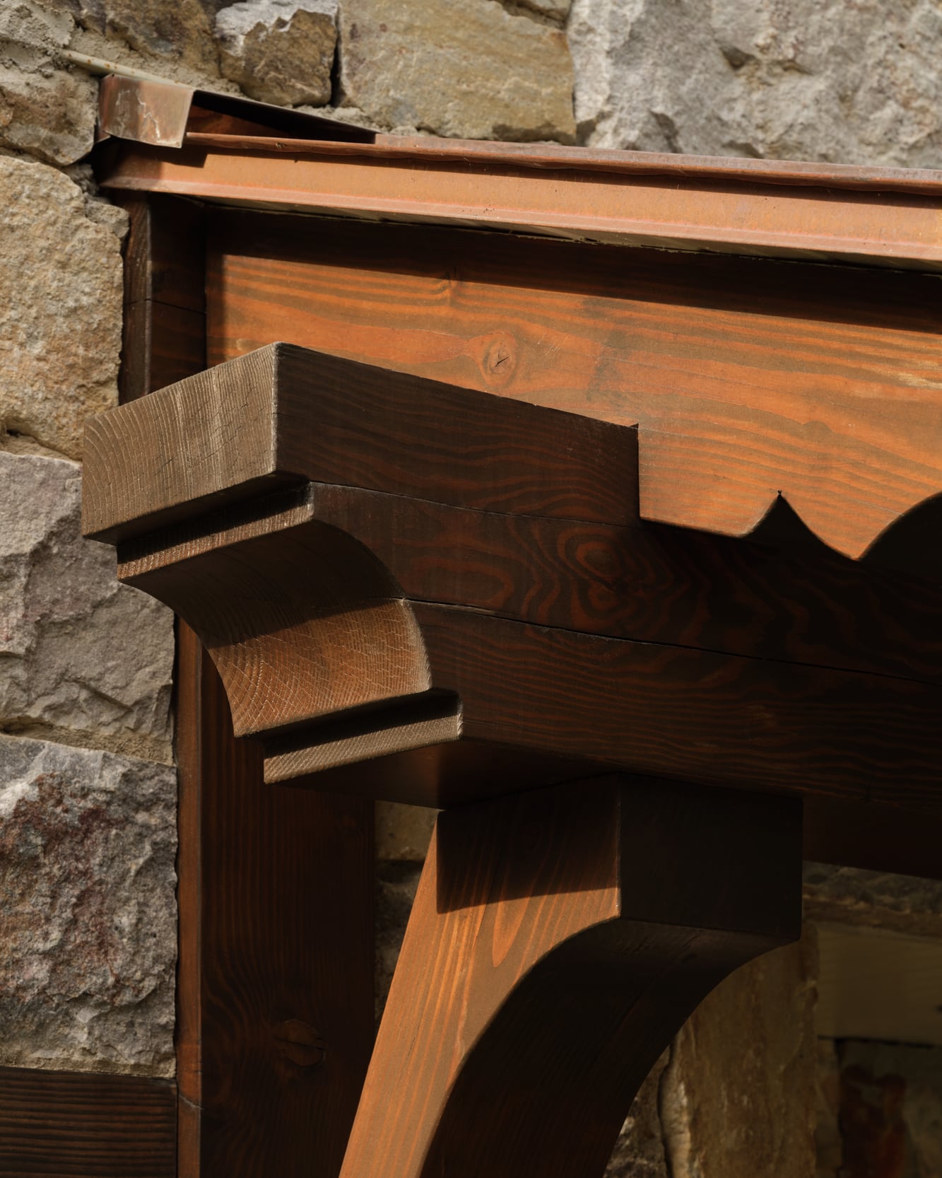 A scrolled bracket and header where the timber meets the stone