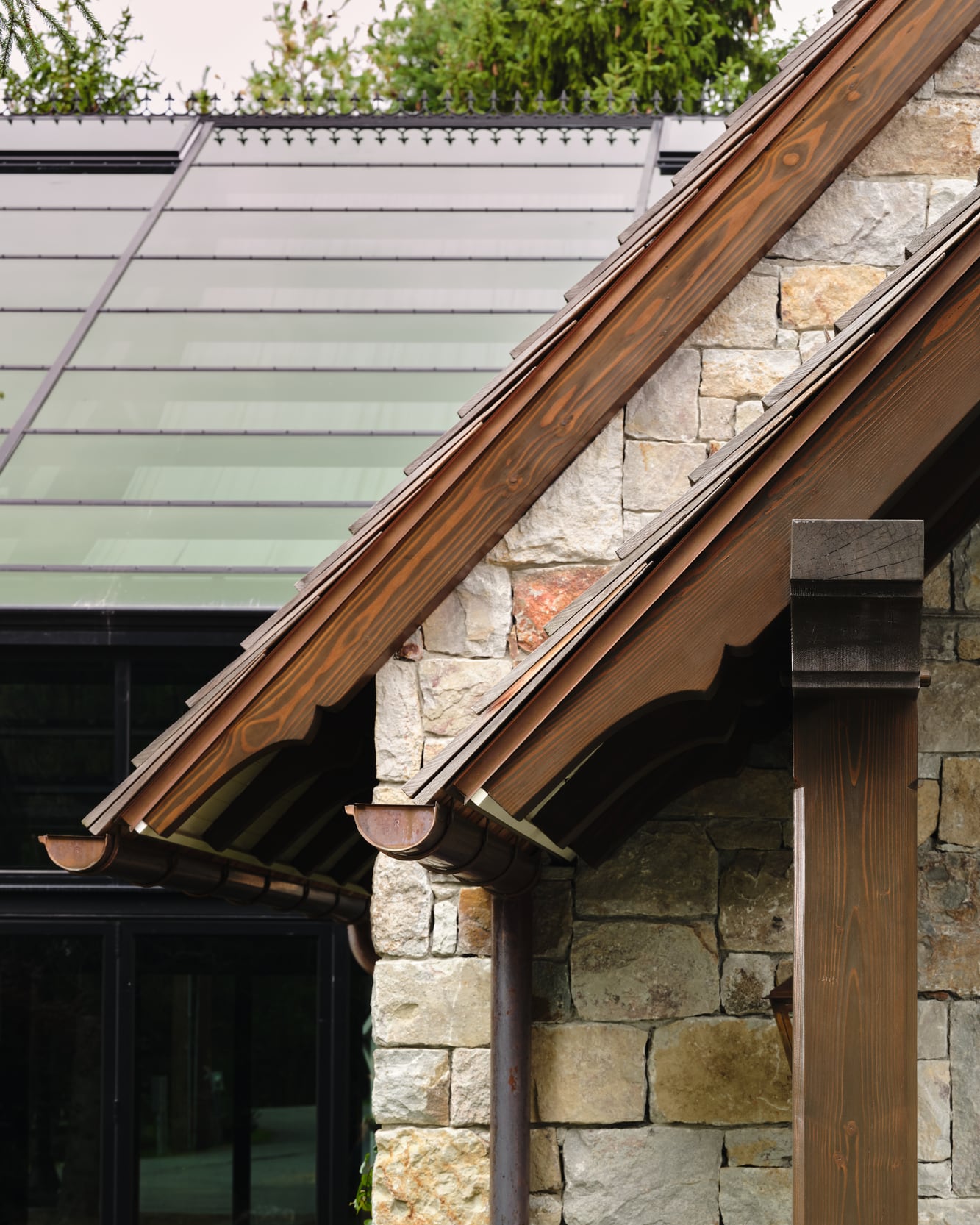 The timber eave and scrolled rafter tails beside the glass roof