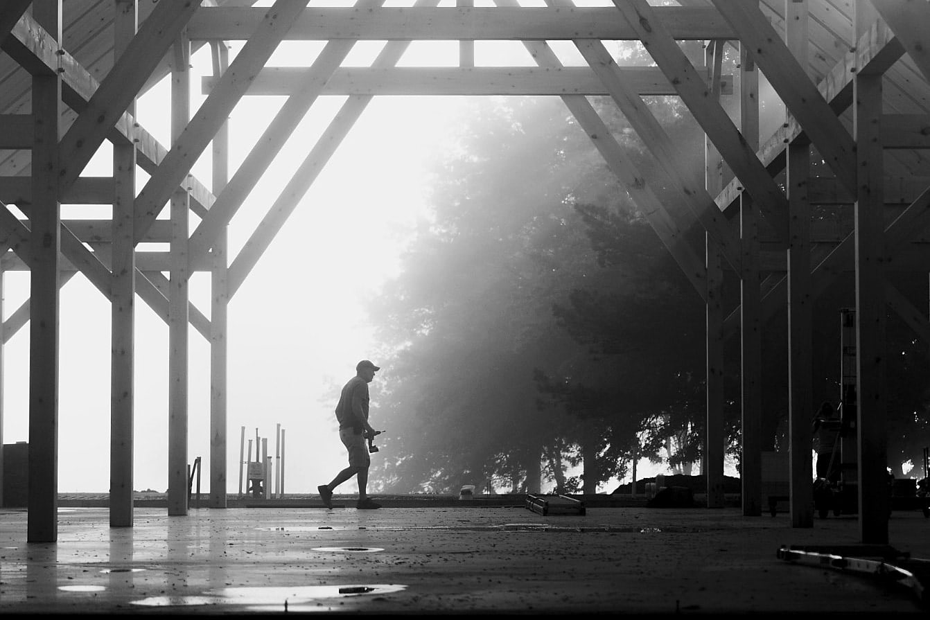 Walking the deck under the raised frame on a foggy morning, black and white
