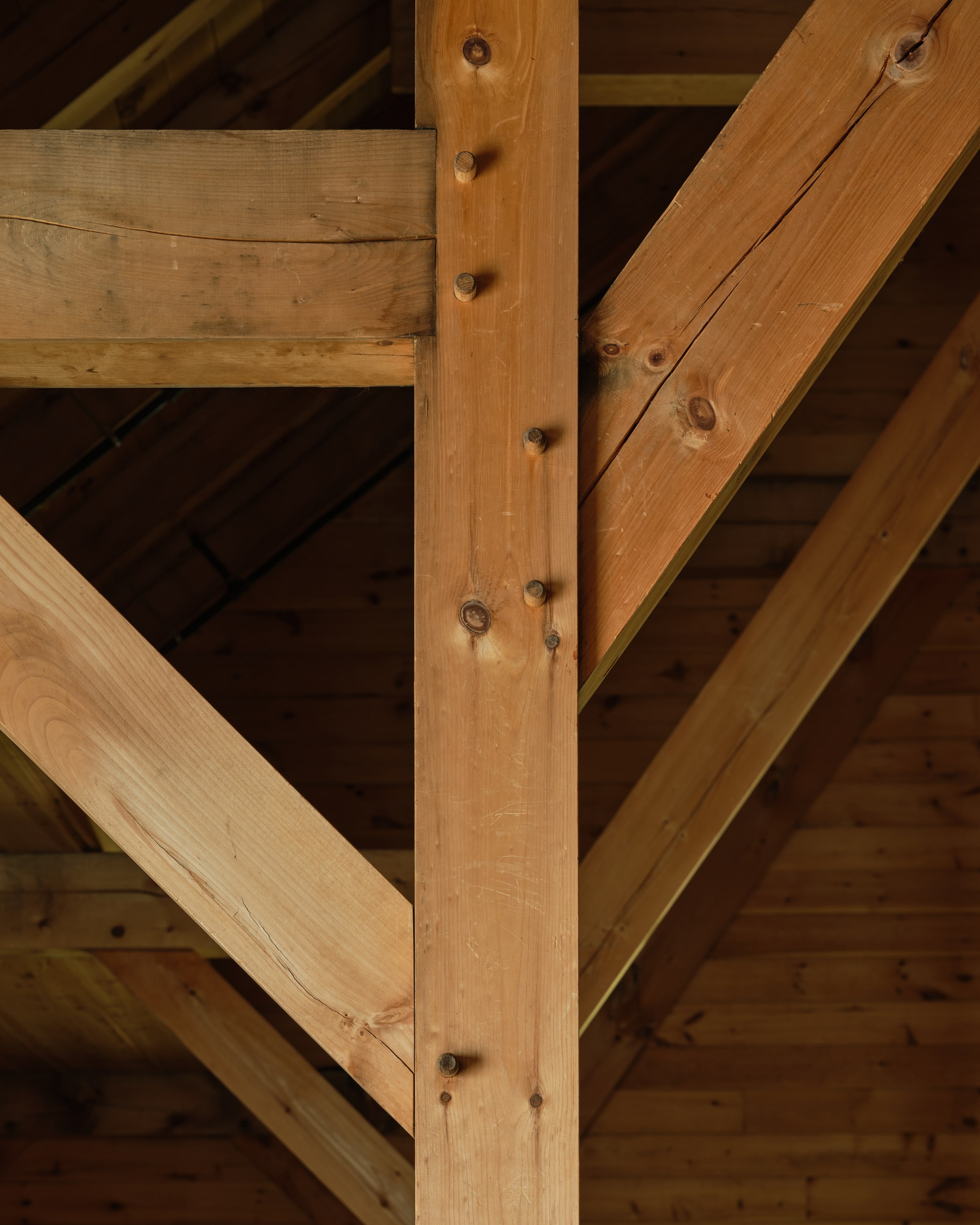 A post, anchor beam, and brace meeting at a pegged joint