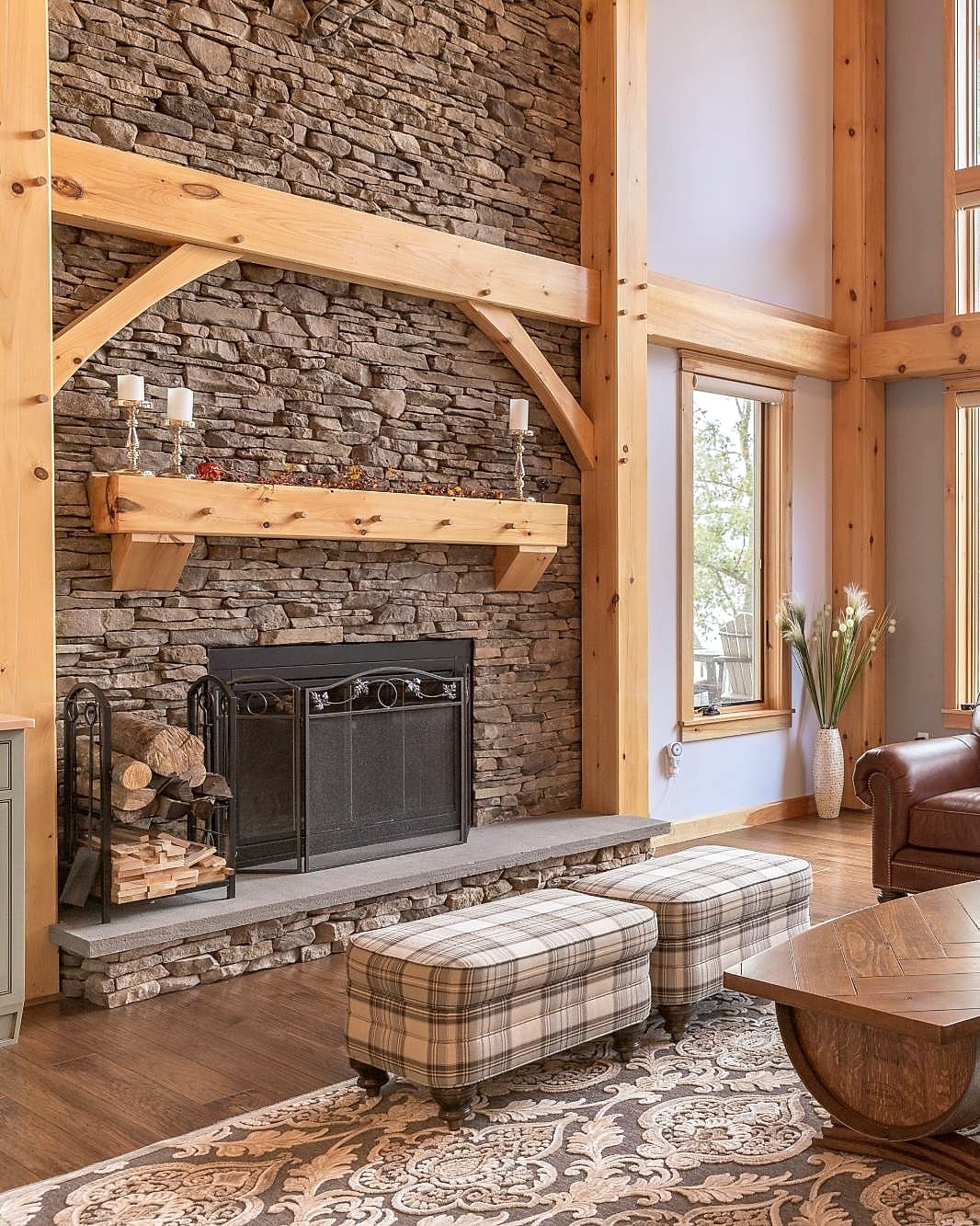 The stone fireplace with its pegged timber mantel and the frame's braces above it