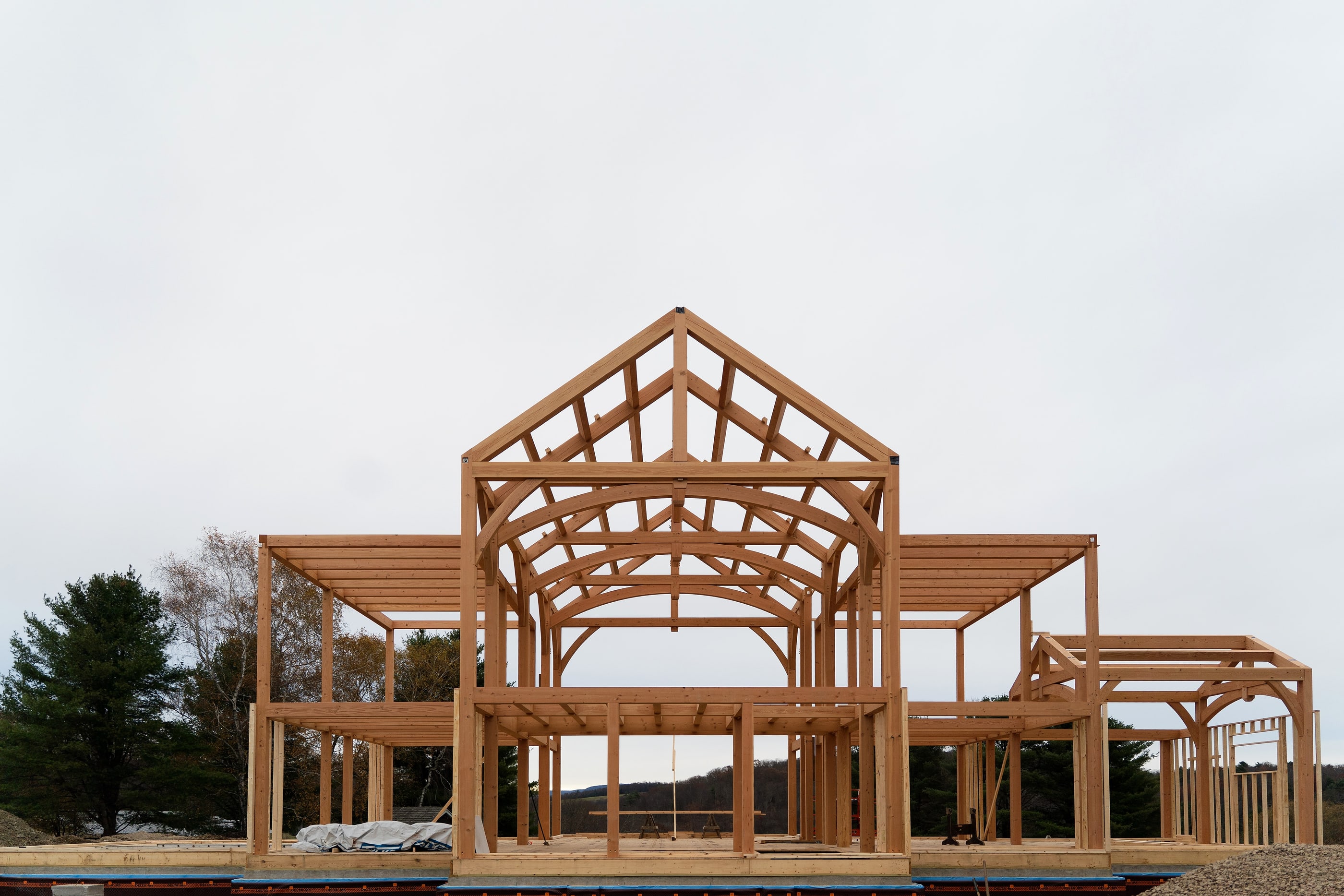 The Mendenhall Hill frame standing on its deck, the great room gable between two wings