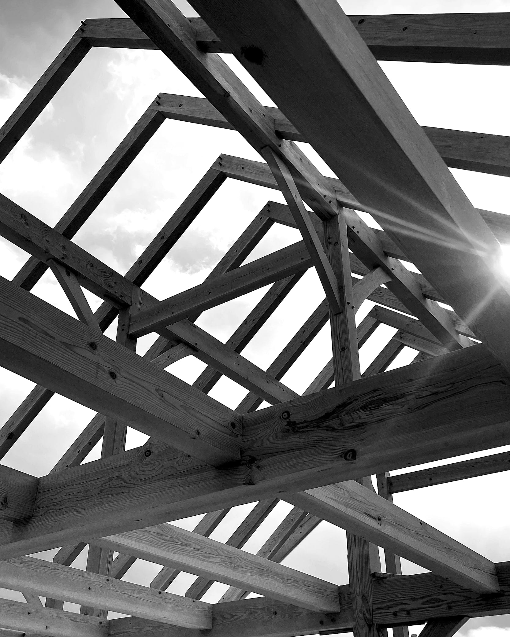 Looking up through the roof frame before the roof went on, black and white